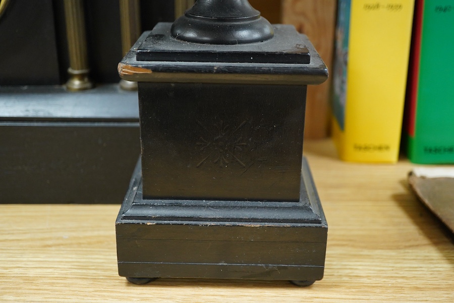 A black slate clock and a pair of garnitures, clock 30cm high. Condition - garnitures worn